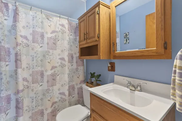 a bathroom with a sink toilet and mirror