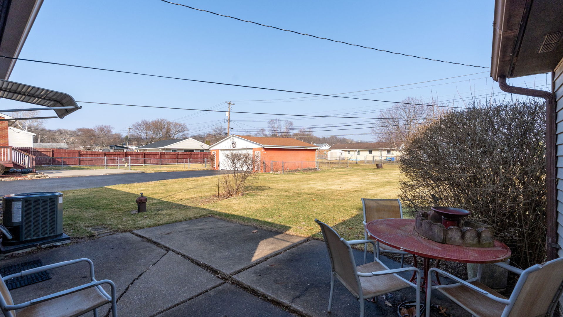 3818 15th Street Moline, IL 61265 - Photo 18 of 23 a view of a swimming pool with a lawn chairs under an umbrella