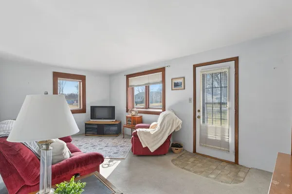 a living room with furniture rug and window