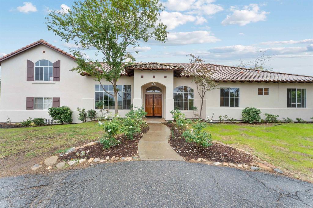 a front view of a house with garden