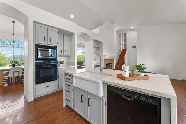 a kitchen with cabinets oven and a sink