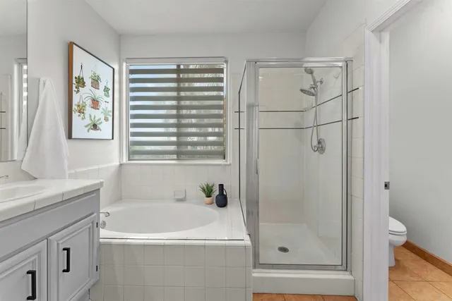 a white toilet sitting next to a white wall