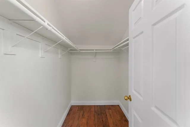 a view of a white house with a yard and garage