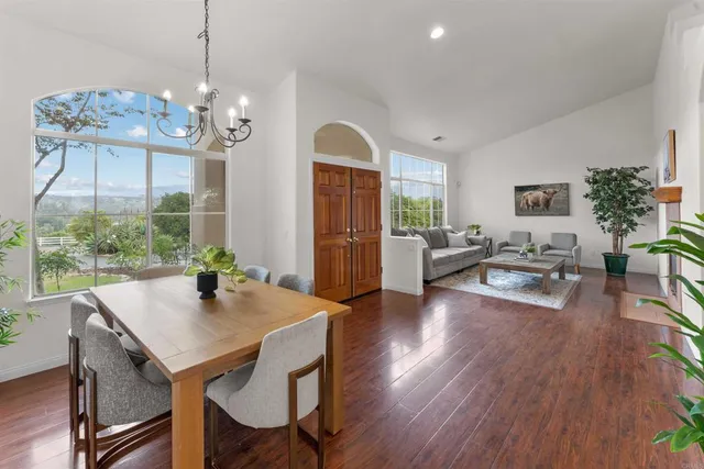 a living room with furniture a large window and a fireplace