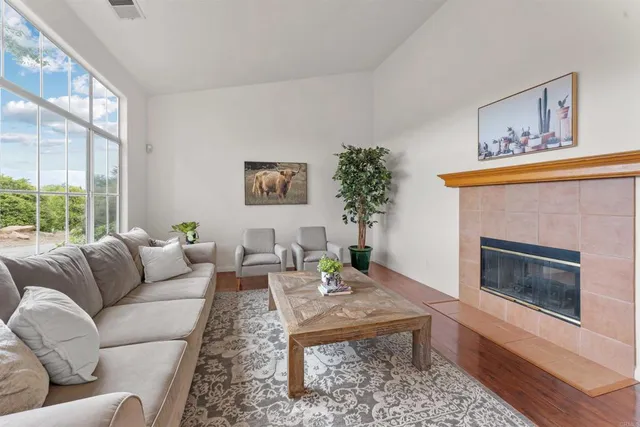 a living room with furniture a fireplace and wooden floor
