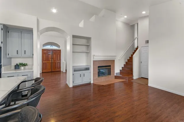 a kitchen with stainless steel appliances a dining table chairs stove refrigerator and cabinets