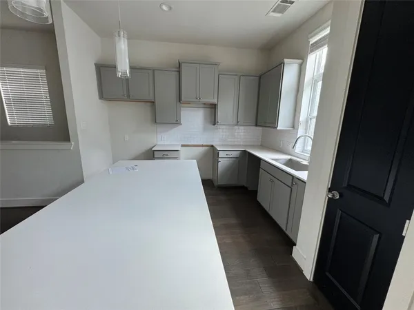 a kitchen with stainless steel appliances a sink stove refrigerator and cabinets