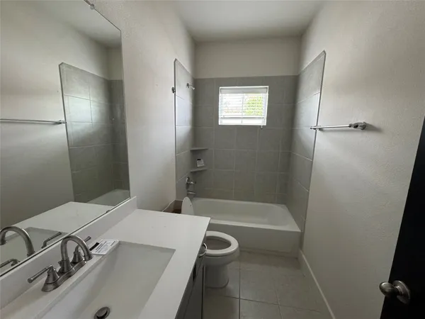 a bathroom with a tub sink and mirror