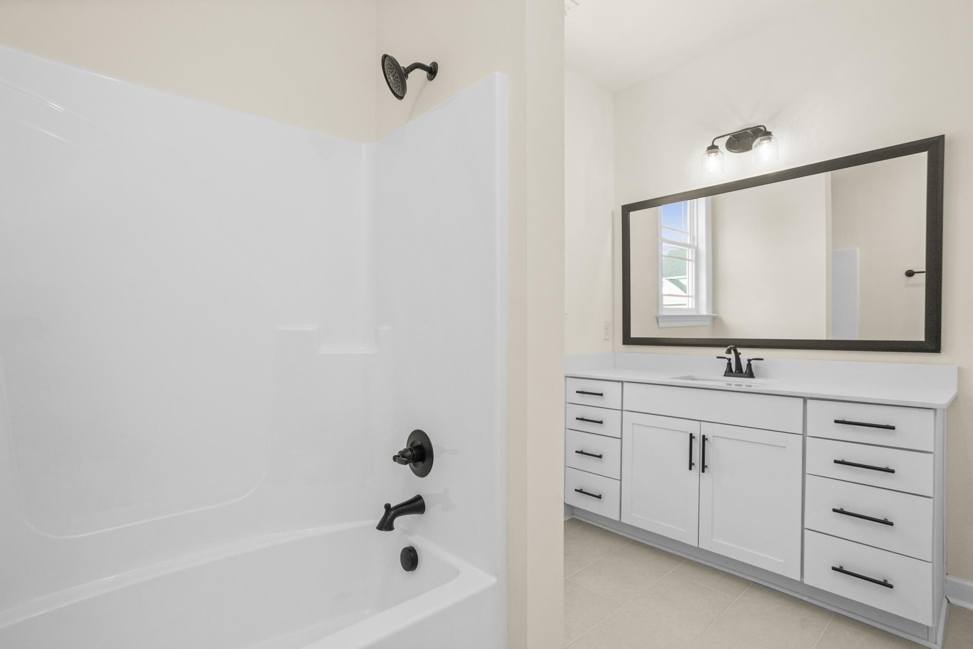 4006 Rampart Way Spring Hill Spring Hill, TN 37174 - Photo 17 of 39 a bathroom with a bathtub a mirror and a sink