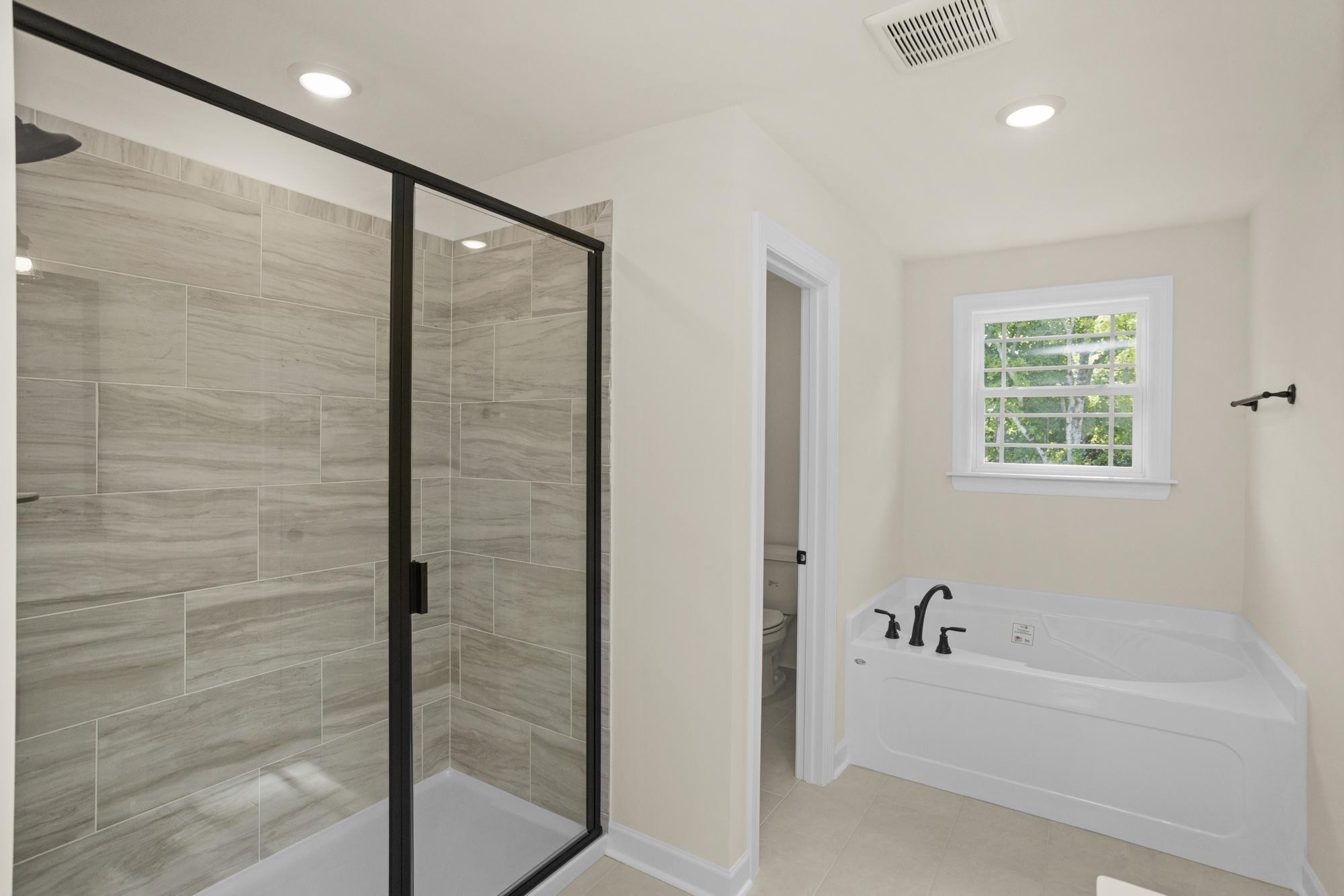 4006 Rampart Way Spring Hill Spring Hill, TN 37174 - Photo 31 of 39 a bathroom with a bathtub and a shower