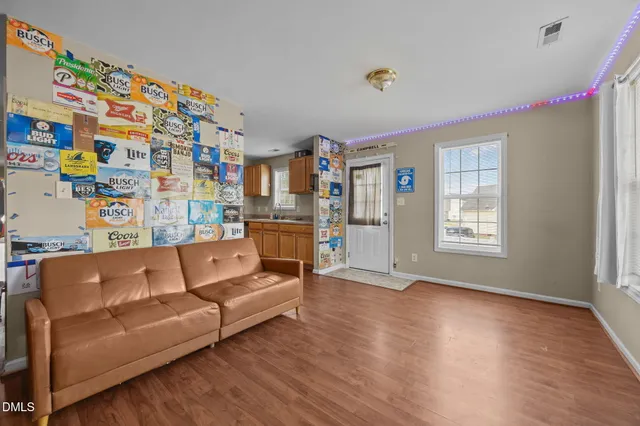 a living room with furniture and a book shelf