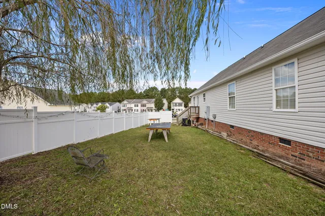 a white bench sitting in backyard of house