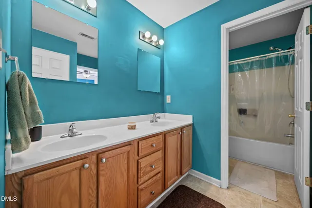 a bathroom with a double vanity sink and a mirror