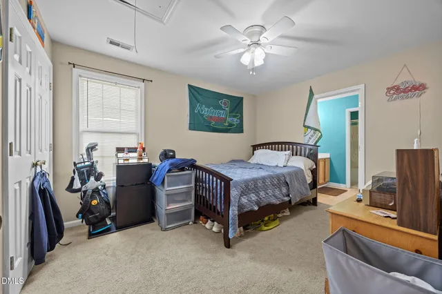 a bedroom with a bed and a couch