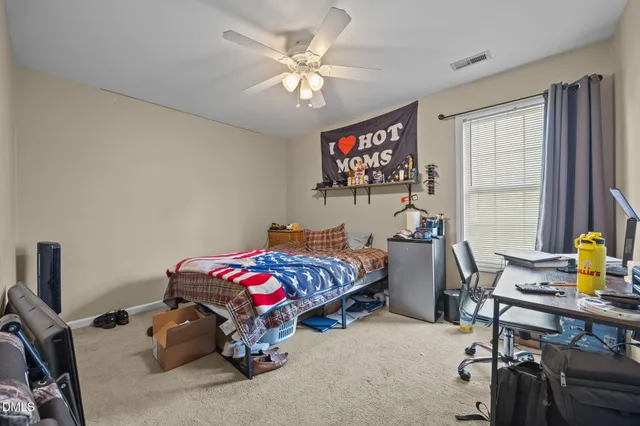 a bedroom with bed and a window