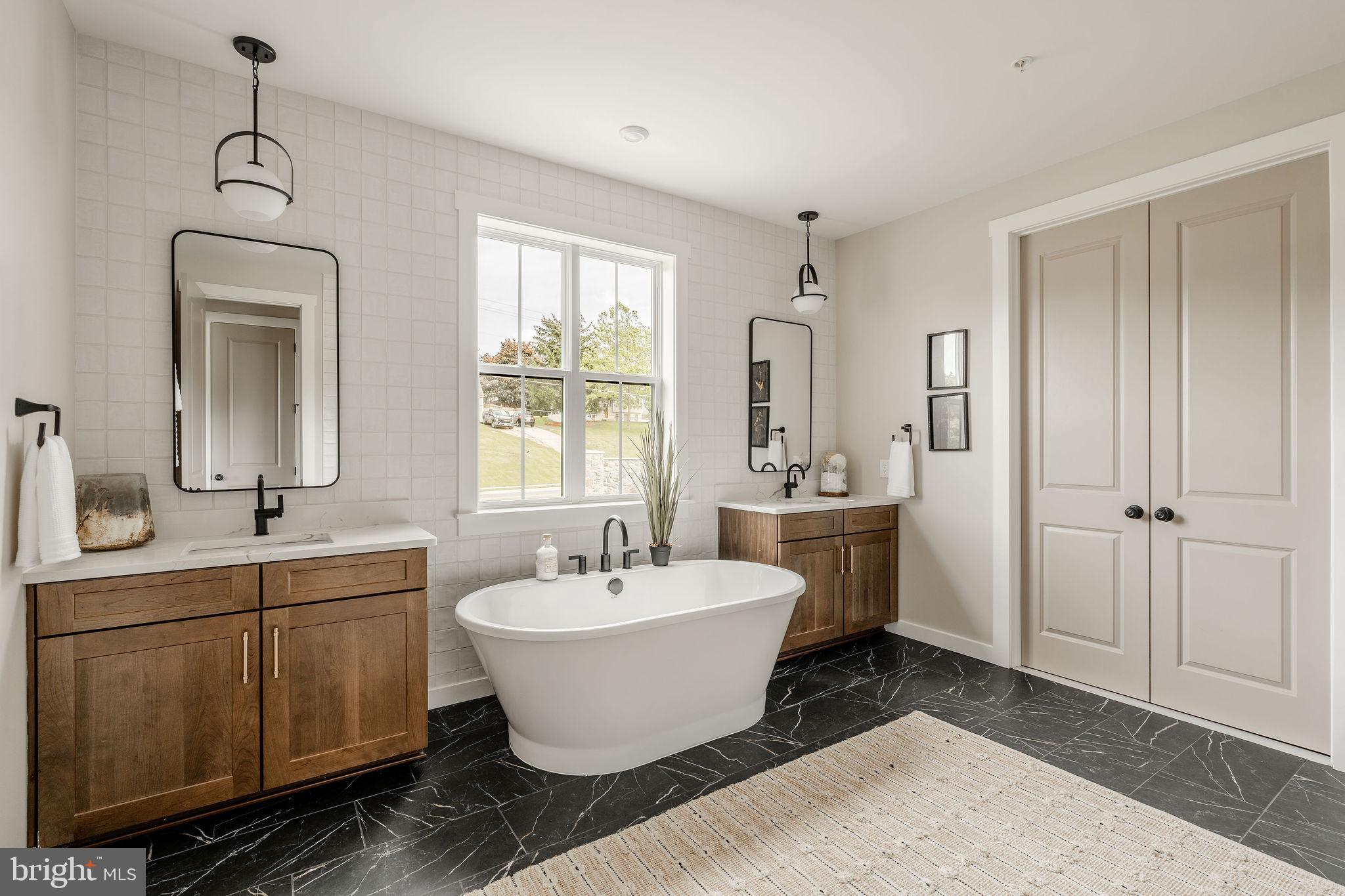 6142 Snowdens Run Road, Unit COVINGTON Eldersburg, MD 21784 - Photo 39 of 48 a view of a bathroom with 2 sink mirror and window