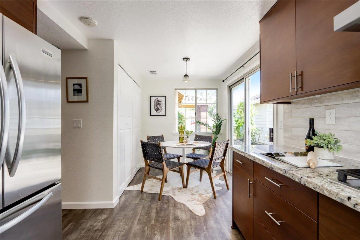 908 Springview Circle San Ramon, CA 94583 - Photo 14 of 31 a dining room with stainless steel appliances granite countertop a refrigerator a sink a stove and chairs with wooden floor