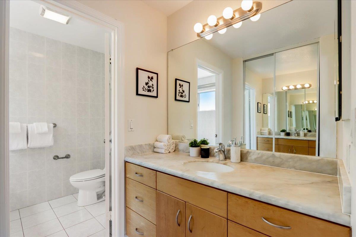908 Springview Circle San Ramon, CA 94583 - Photo 20 of 31 a bathroom with a granite countertop sink a large mirror and a toilet