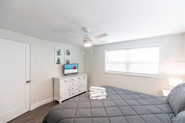 a living room with a baby crib furniture and a window