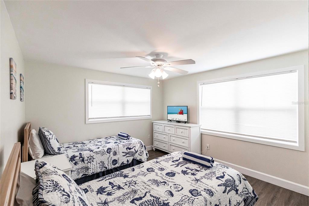 6020 Midnight Pass Road, Unit 49 Sarasota, FL 34242 - Photo 16 of 38 a bedroom with a bed and a window with chair