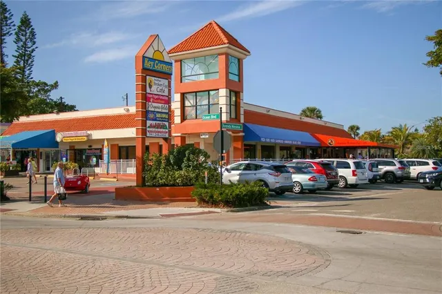 a front view of building with cars parked