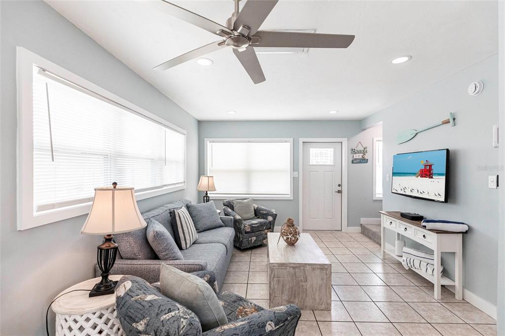 6020 Midnight Pass Road, Unit 49 Sarasota, FL 34242 - Photo 5 of 38 a living room with furniture and a flat screen tv