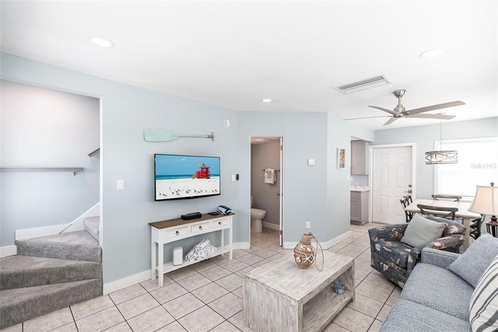 6020 Midnight Pass Road, Unit 49 Sarasota, FL 34242 - Photo 6 of 38 a living room with furniture and a flat screen tv