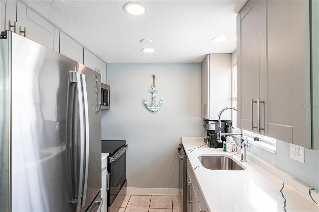 6020 Midnight Pass Road, Unit 49 Sarasota, FL 34242 - Photo 7 of 38 a bathroom with a sink a toilet and a mirror