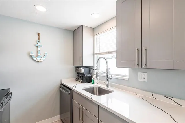 a kitchen with a sink cabinets and window