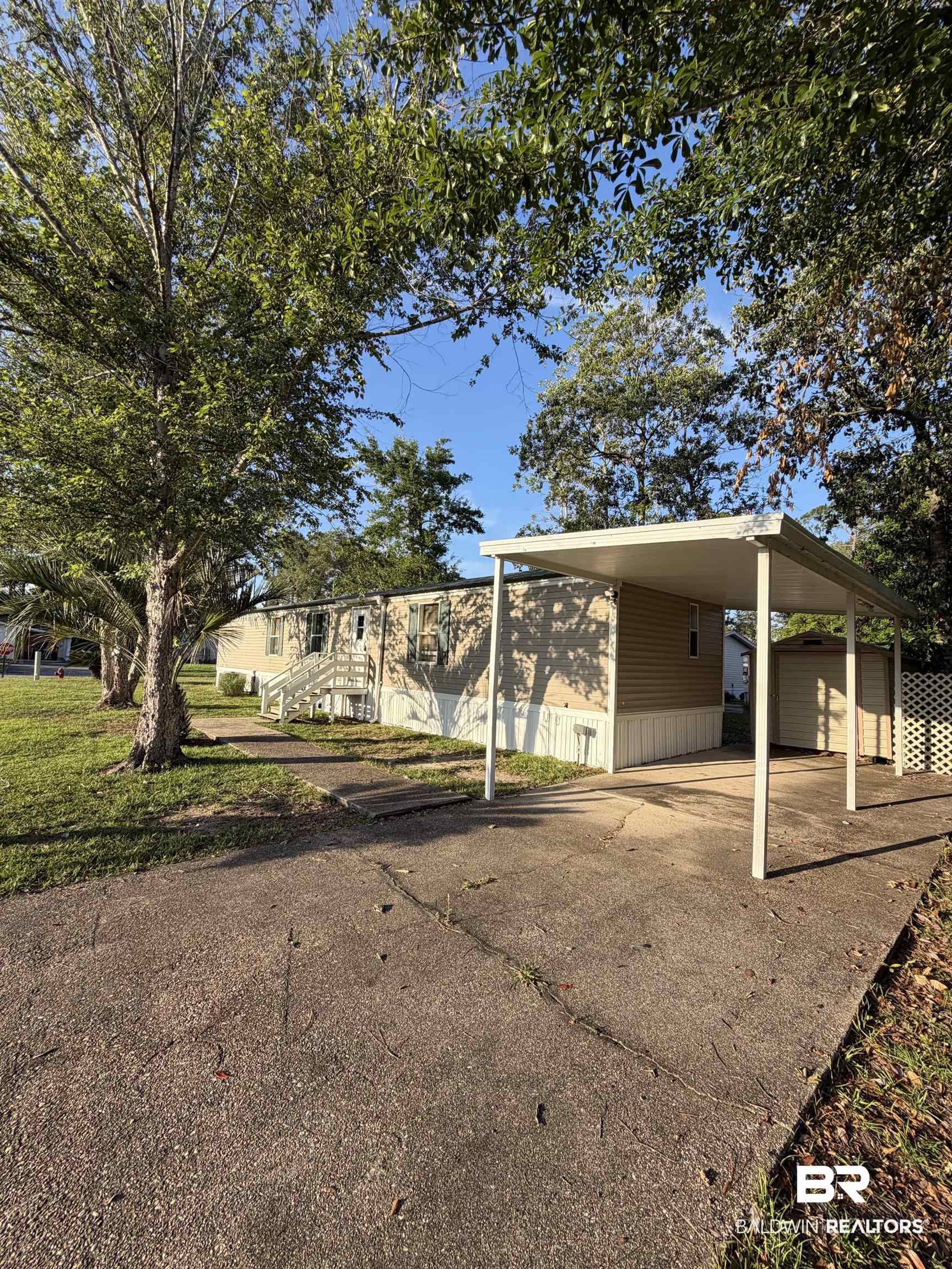 1125 Ridgewood Drive Lillian, AL 36549 - Photo 1 of 36 Exterior featuring a beige siding, white trim, and a white carport