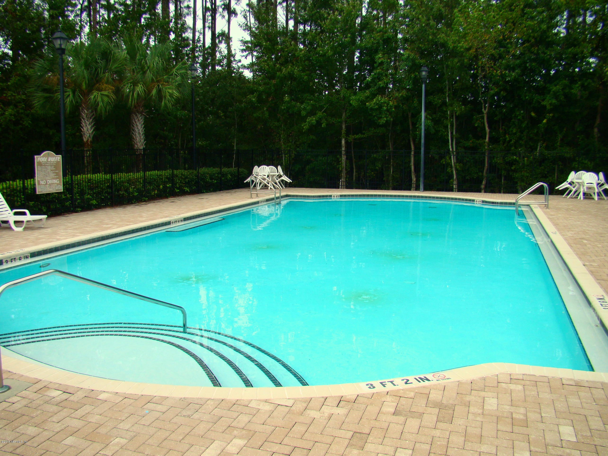 a view of a swimming pool with a yard