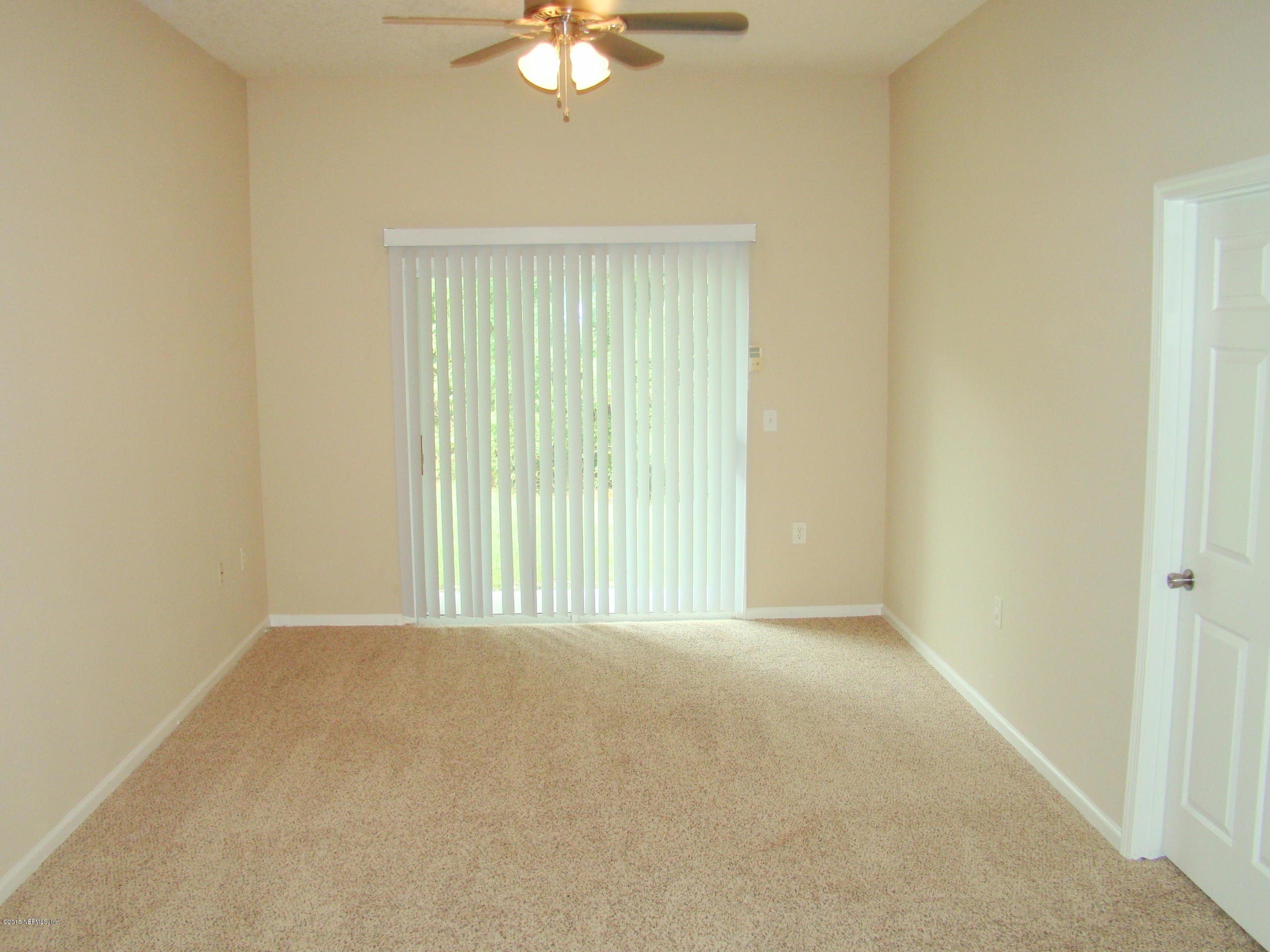 7920 Merrill Road, Unit 1504 Jacksonville, FL 32277 - Photo 2 of 12 a view of an empty room with a window