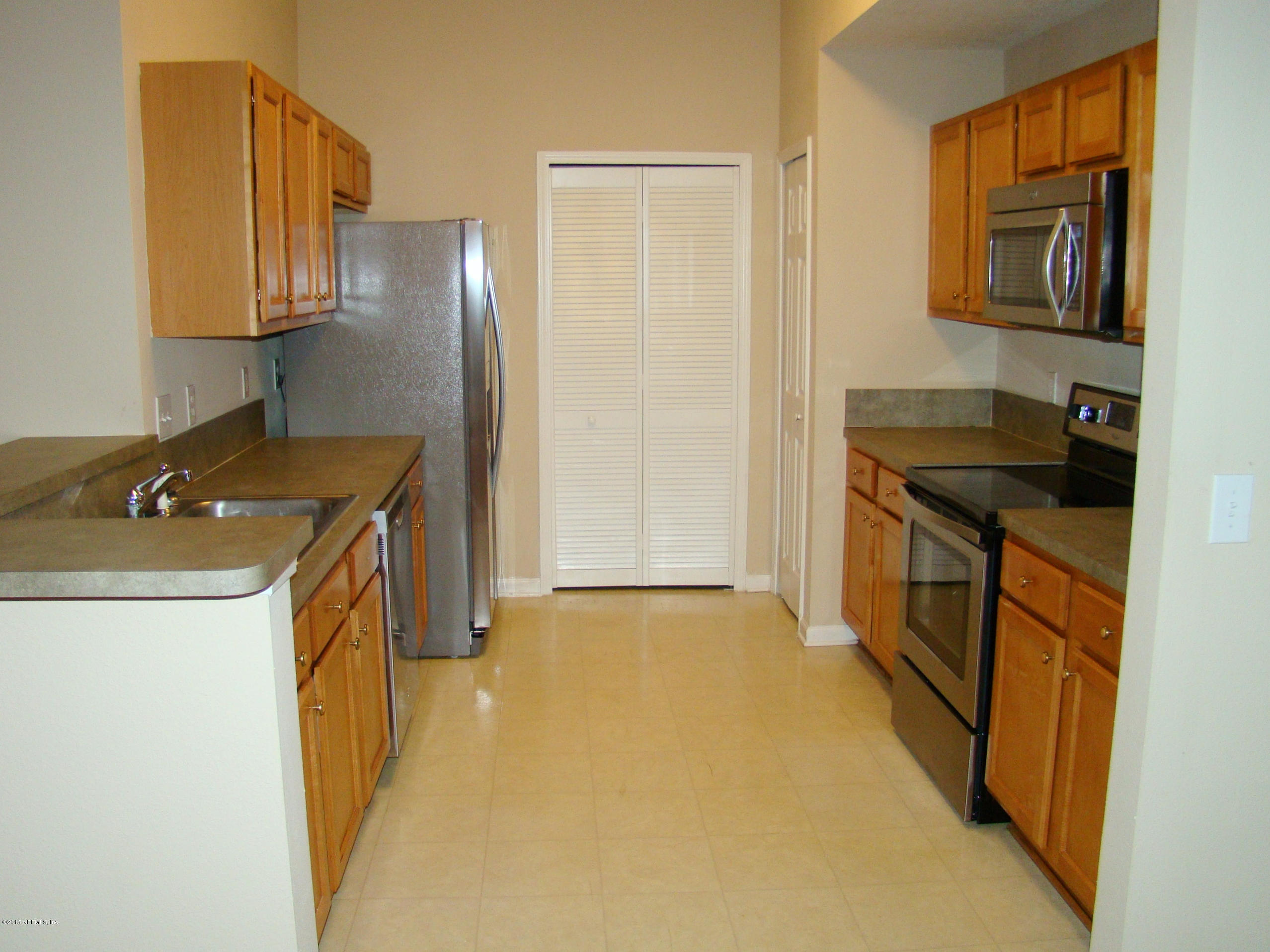 7920 Merrill Road, Unit 1504 Jacksonville, FL 32277 - Photo 6 of 12 a utility room with cabinets washer and dryer