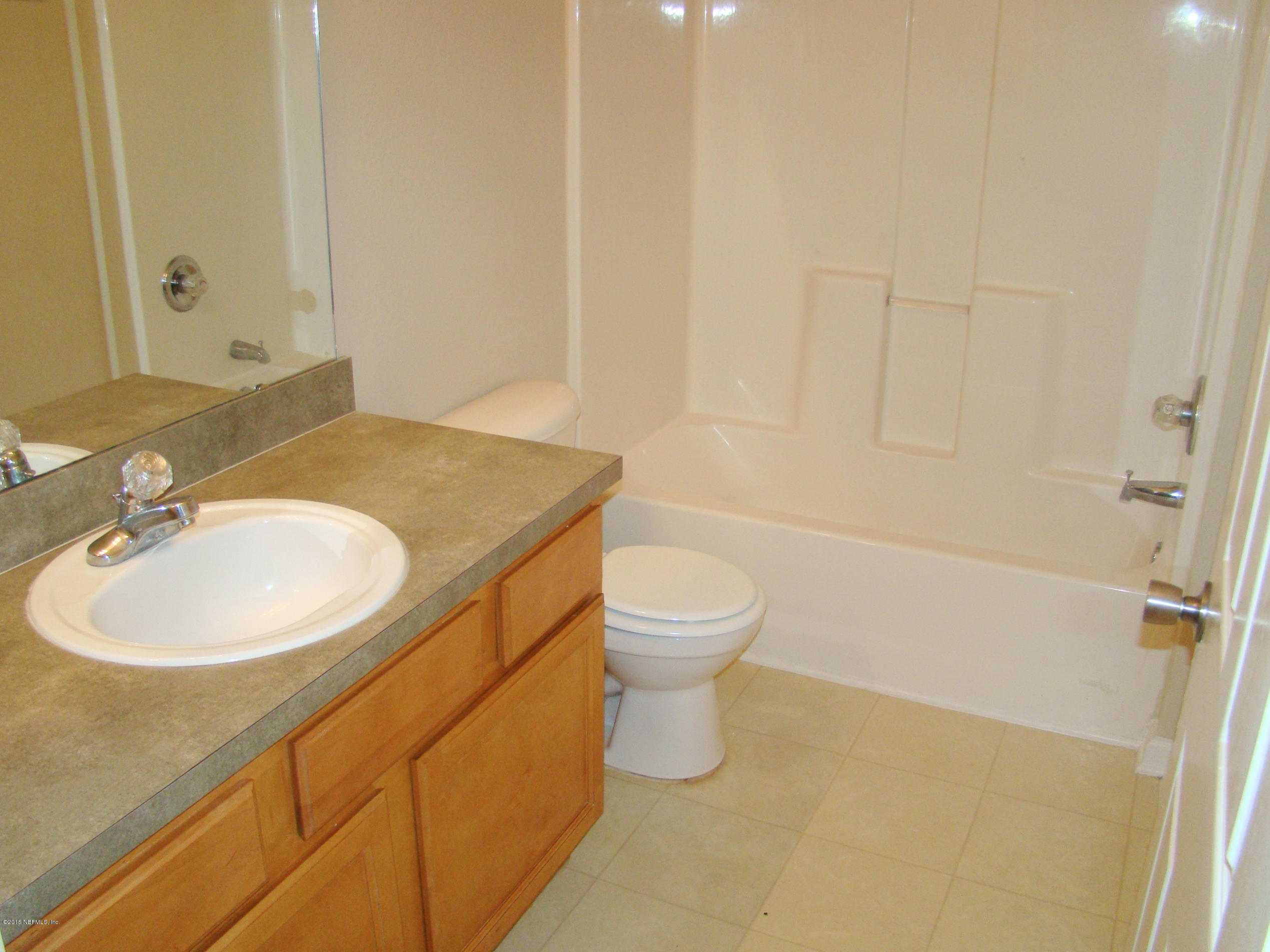 7920 Merrill Road, Unit 1504 Jacksonville, FL 32277 - Photo 8 of 12 a bathroom with a sink a toilet and shower