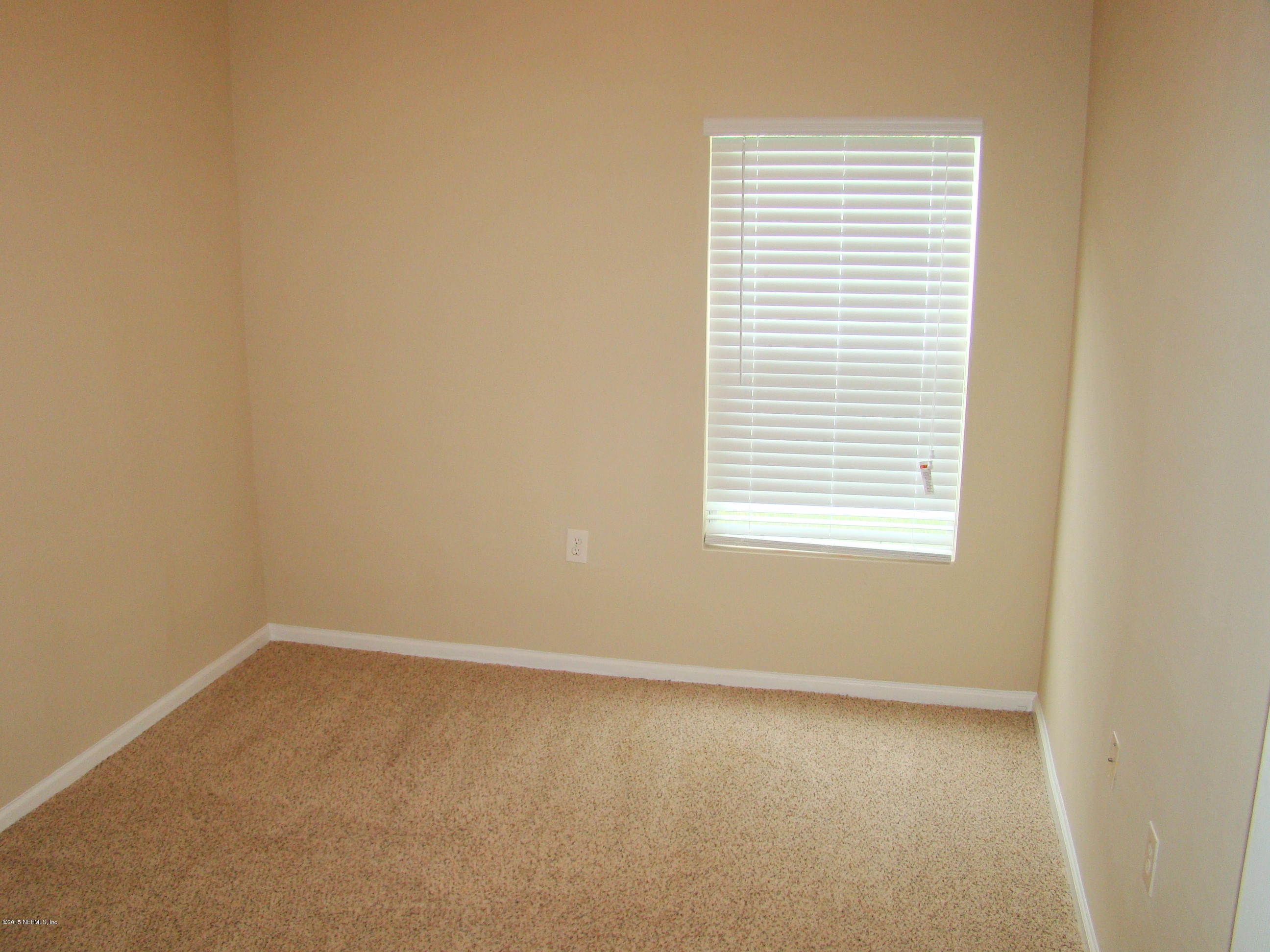 7920 Merrill Road, Unit 1504 Jacksonville, FL 32277 - Photo 9 of 12 an empty room with a window