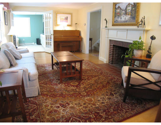 67 Scott Road Belmont, MA 02478 - Photo 4 of 12 a living room with furniture a fireplace and a table