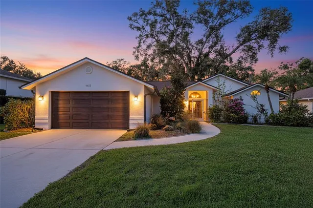 a front view of a house with patio and garden
