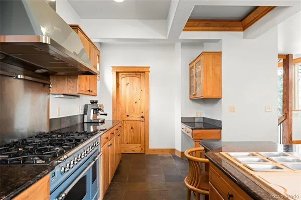 a kitchen with a stove and a refrigerator