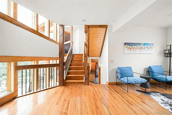a view of staircase with furniture and a window