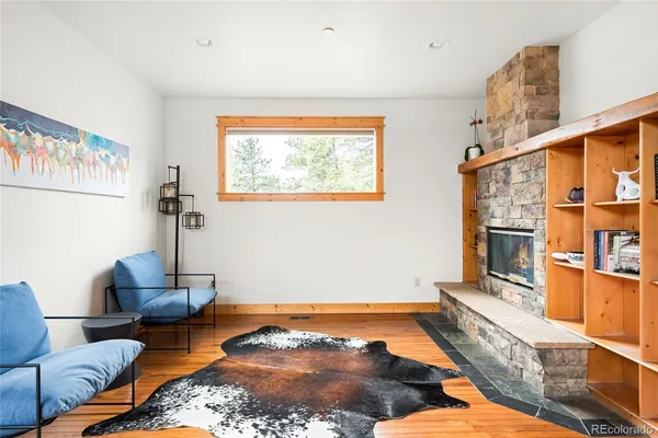 a living room with furniture rug and a window