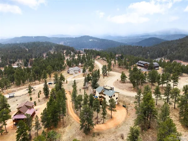 a view of a town with mountains in the background