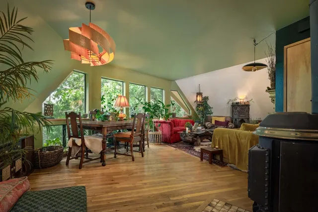 a bedroom with a bed and large windows