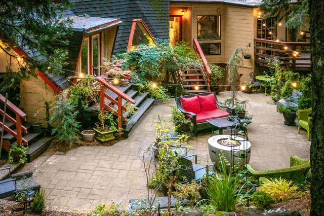 a view of a patio with table and chairs and a barbeque