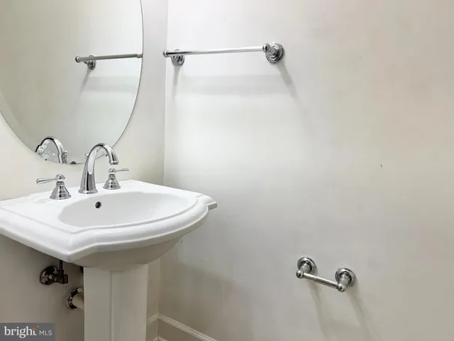 a bathroom with a sink a mirror and a shower