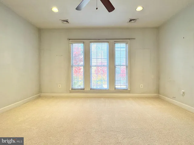 an empty room with a empty space and windows