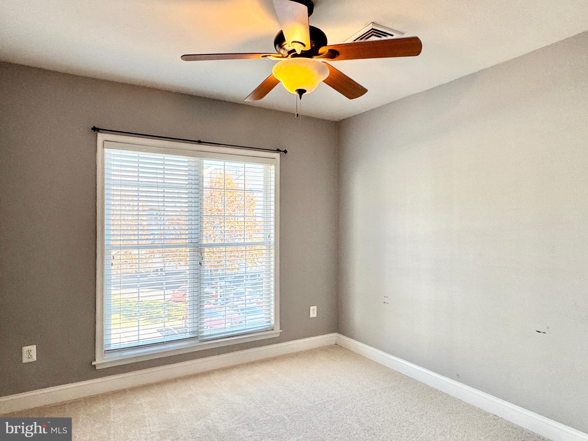 2396 Brookmoor Lane, Unit 401A Woodbridge, VA 22191 - Photo 23 of 26 an empty room with a window and a chandelier fan
