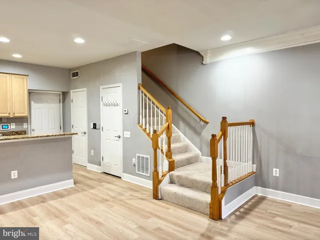 a view of an entryway with wooden floor and door