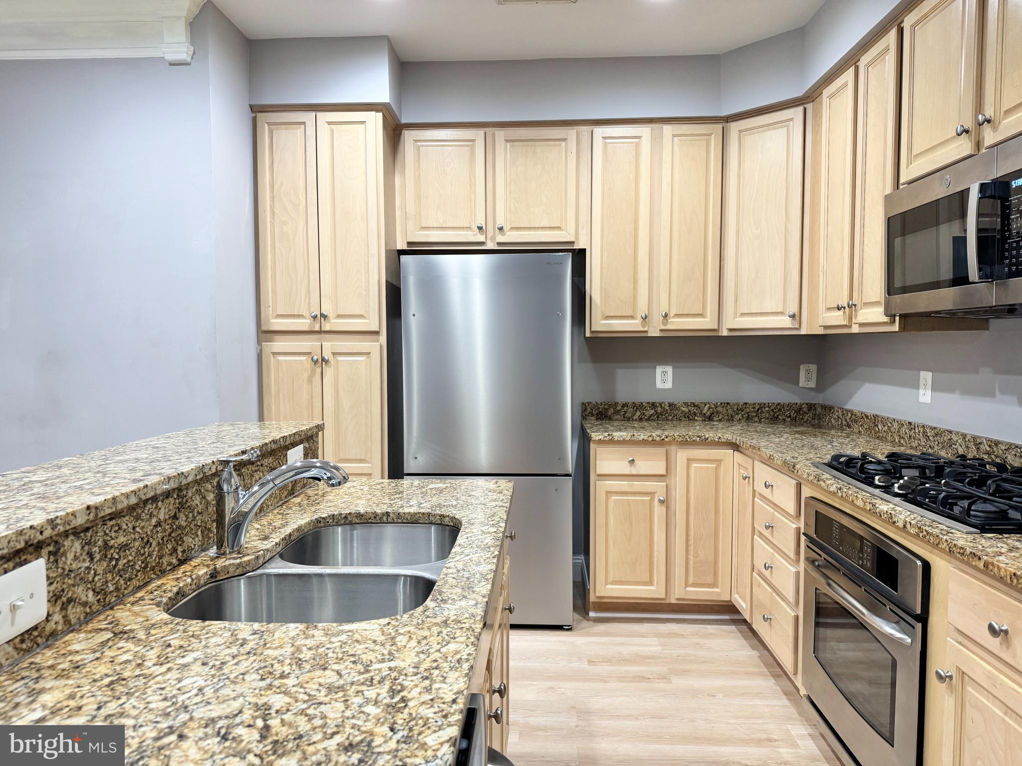 2396 Brookmoor Lane, Unit 401A Woodbridge, VA 22191 - Photo 7 of 26 a kitchen with stainless steel appliances granite countertop a sink stove and refrigerator