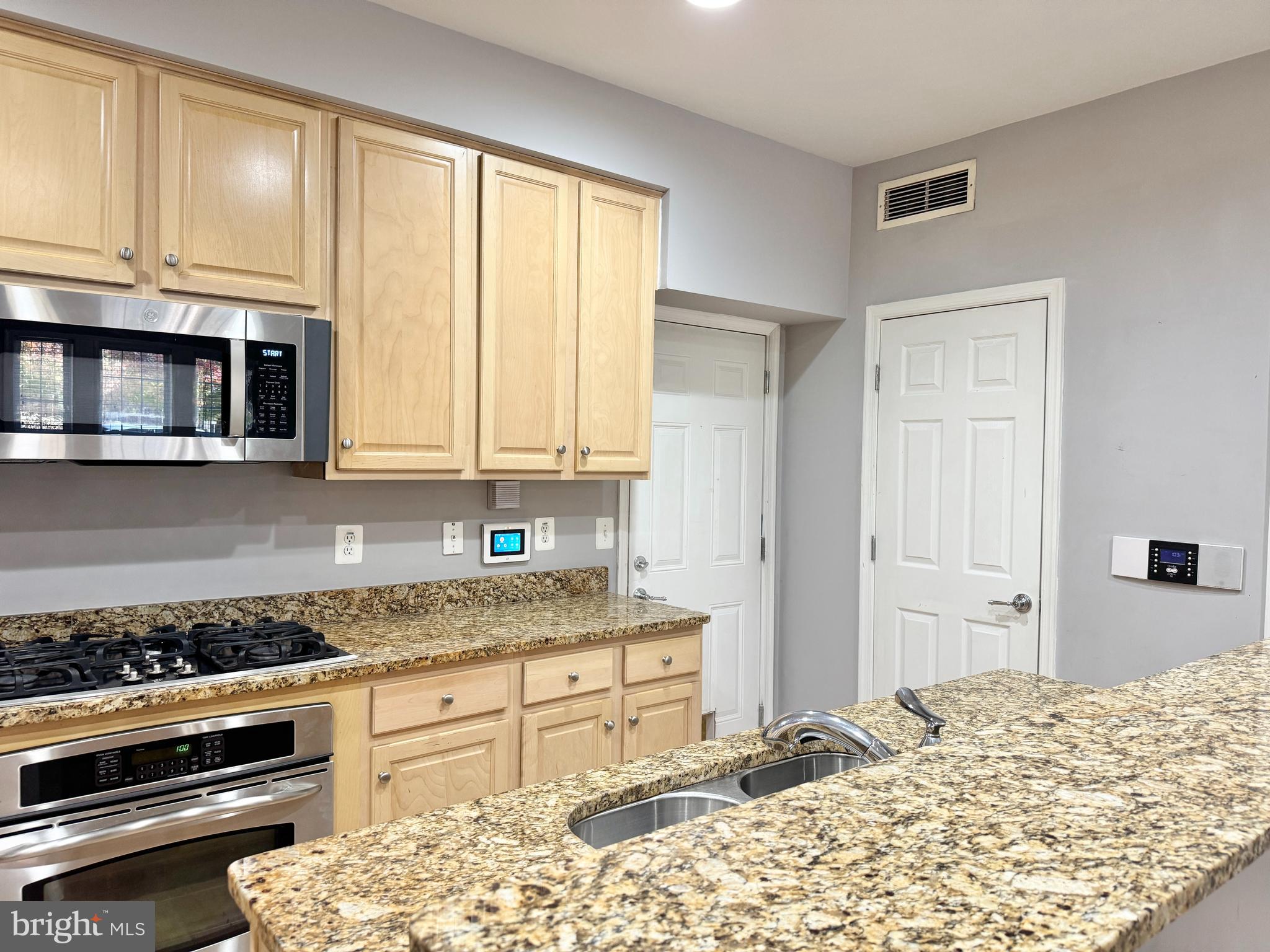 2396 Brookmoor Lane, Unit 401A Woodbridge, VA 22191 - Photo 8 of 26 a kitchen with a stove a sink and a microwave