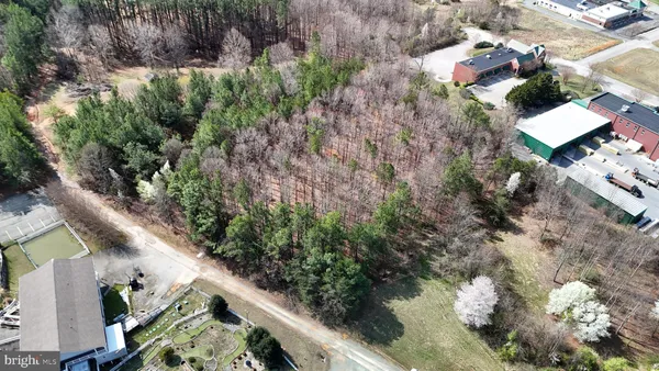 an aerial view of a house with a yard and lake view